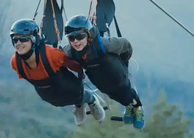 Vuelo en la tirolina más rápida del mundo, con un adulto y un niño compartiendo la experiencia.