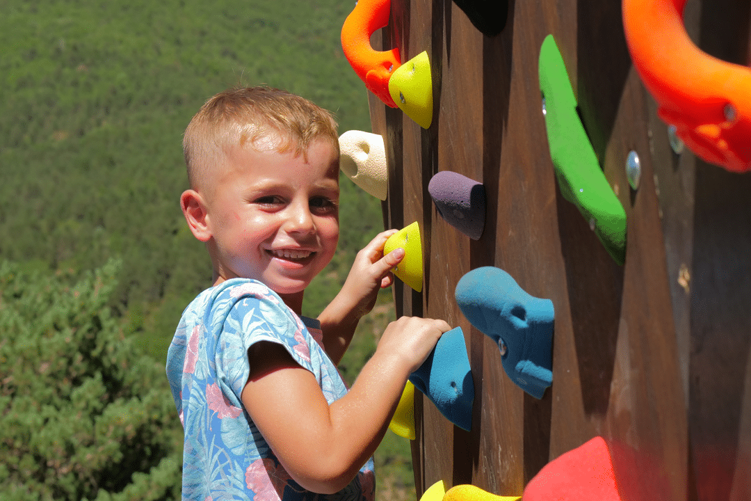 Niño escalando en el rocodromo